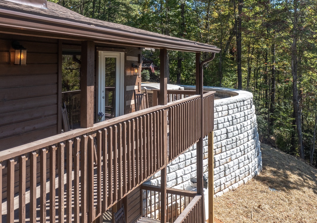 A charming cabin-style retreat nestled among towering hardwoods, offering peace and privacy in a natural woodland setting.