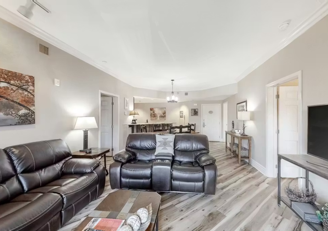 Sink into plush leather recliners while you enjoy movie nights in this spacious living area with elegant finishes and open-concept design.