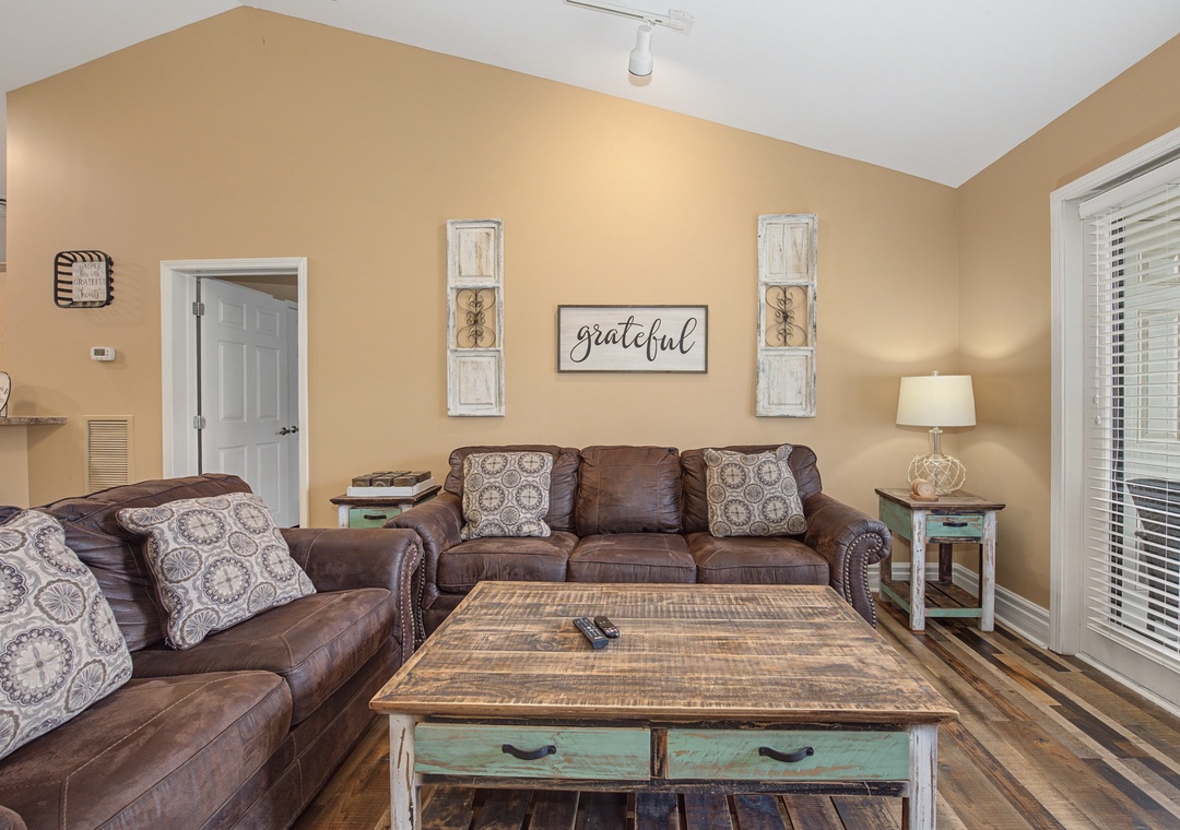 Unwind in your cozy living room with plush leather sofas and rustic charm that makes every moment feel like home.