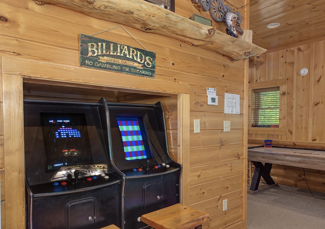 Challenge friends to classic arcade games in your cozy cabin game room, complete with vintage billiards and rustic charm.
