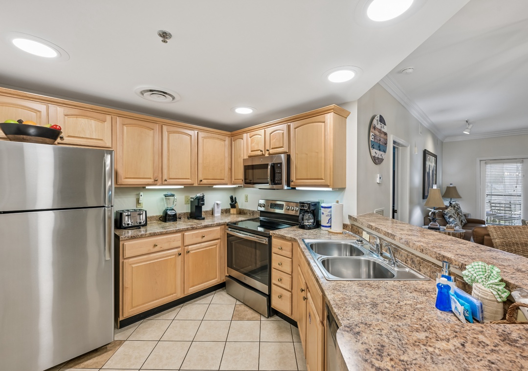 Your fully equipped kitchen features granite countertops, stainless steel appliances, and ample cabinet space for preparing memorable meals during your stay.