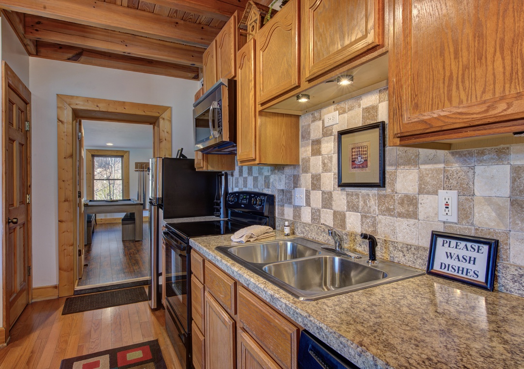 Your fully equipped kitchen features granite counters, stone backsplash, and everything needed to prepare memorable meals during your mountain getaway.