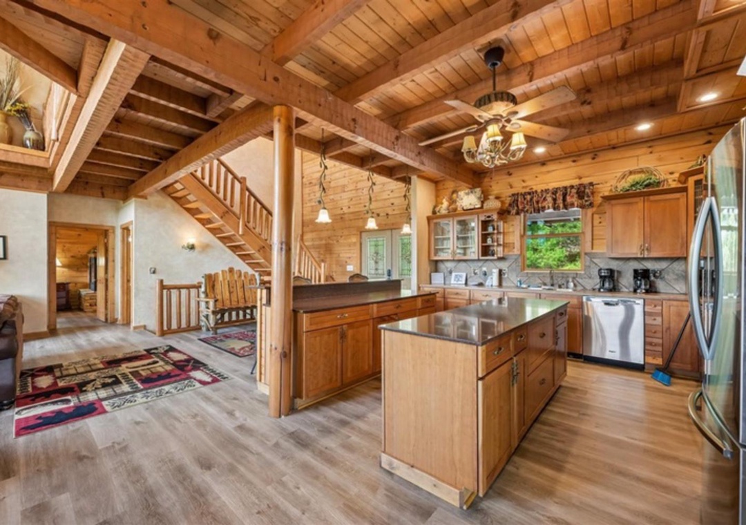 Step into your open-concept cabin retreat with soaring wood ceilings, modern kitchen island, and cozy mountain touches throughout this spacious lodge-style sanctuary.