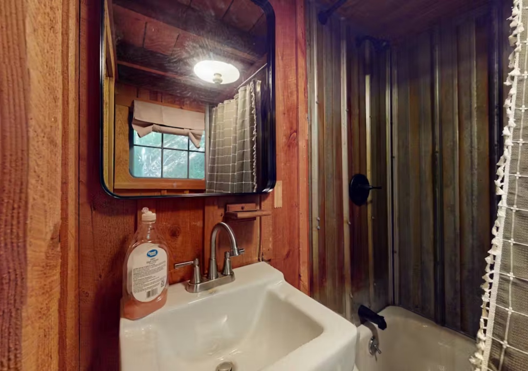 Step into your rustic bathroom where warm wood meets modern comfort, complete with a cozy shower for refreshing starts to mountain adventures.
