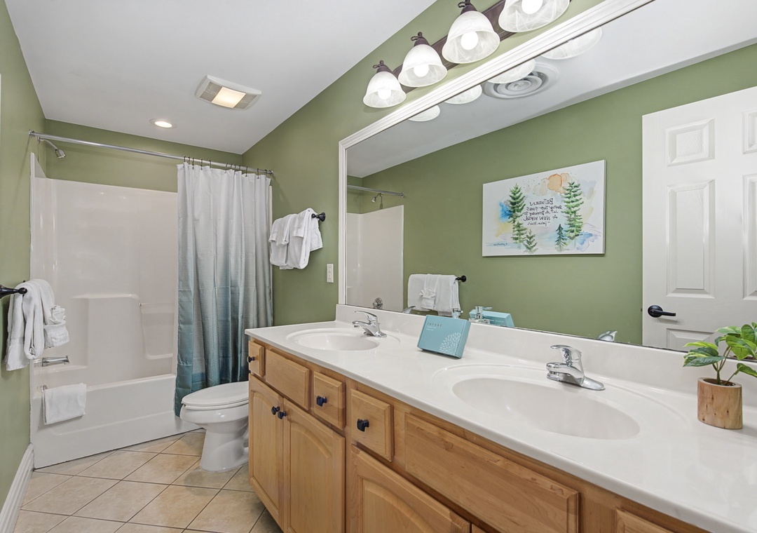 Refresh in your spacious bathroom with dual sinks, soaking tub, and calming sage walls that create a spa-like retreat.