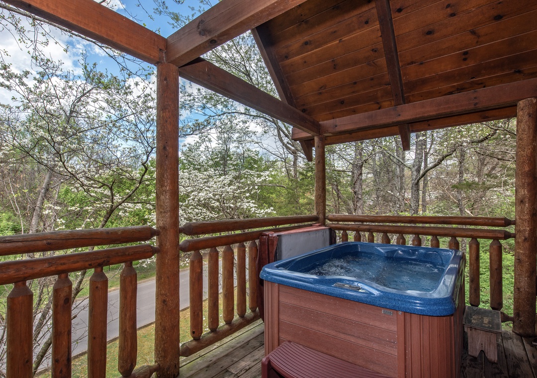 Soak in your private hot tub while surrounded by blooming dogwood trees and peaceful forest views on the covered deck.