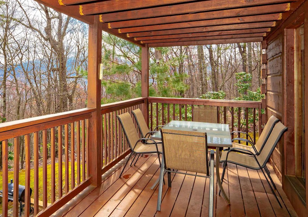 Your covered deck provides the perfect spot for morning coffee or evening meals while enjoying peaceful forest views.