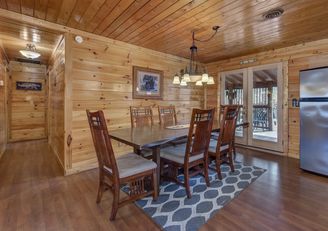 Gather around this beautiful wooden dining table where your family meals become cherished memories in this warm, rustic cabin atmosphere.
