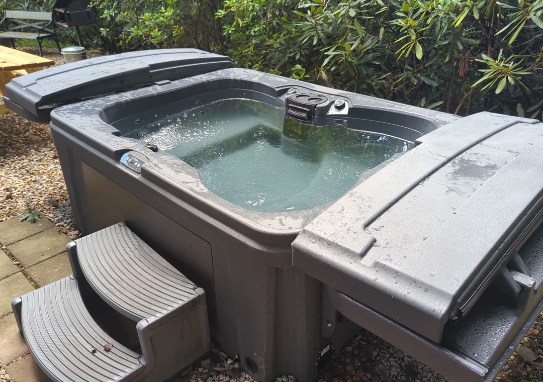 Slip into your private hot tub and feel the warm bubbles melt away the day's stress. Nestled among lush greenery, this outdoor oasis offers pure relaxation under the open sky.