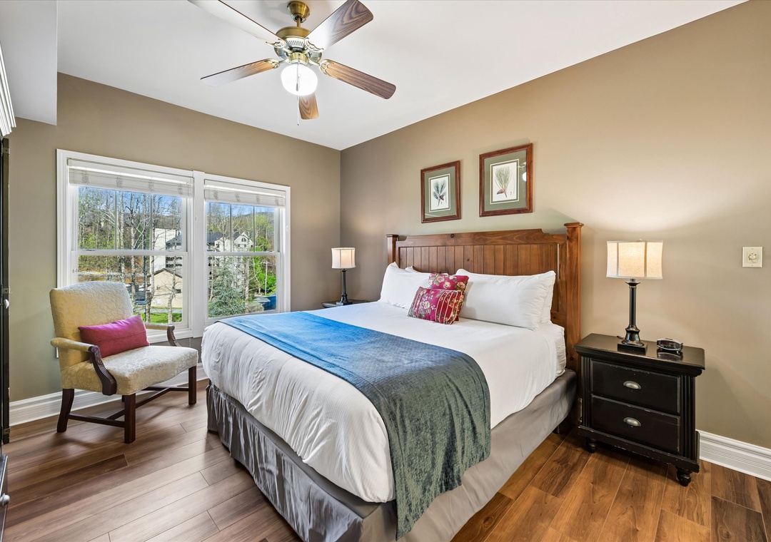 Unwind in your comfortable bedroom with crisp linens, warm wood touches, and peaceful views through large windows.