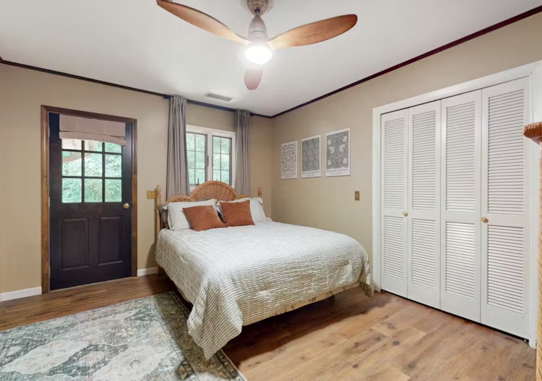 Unwind in your peaceful bedroom featuring warm wood floors, a cozy ceiling fan, and ample closet space for all your belongings.