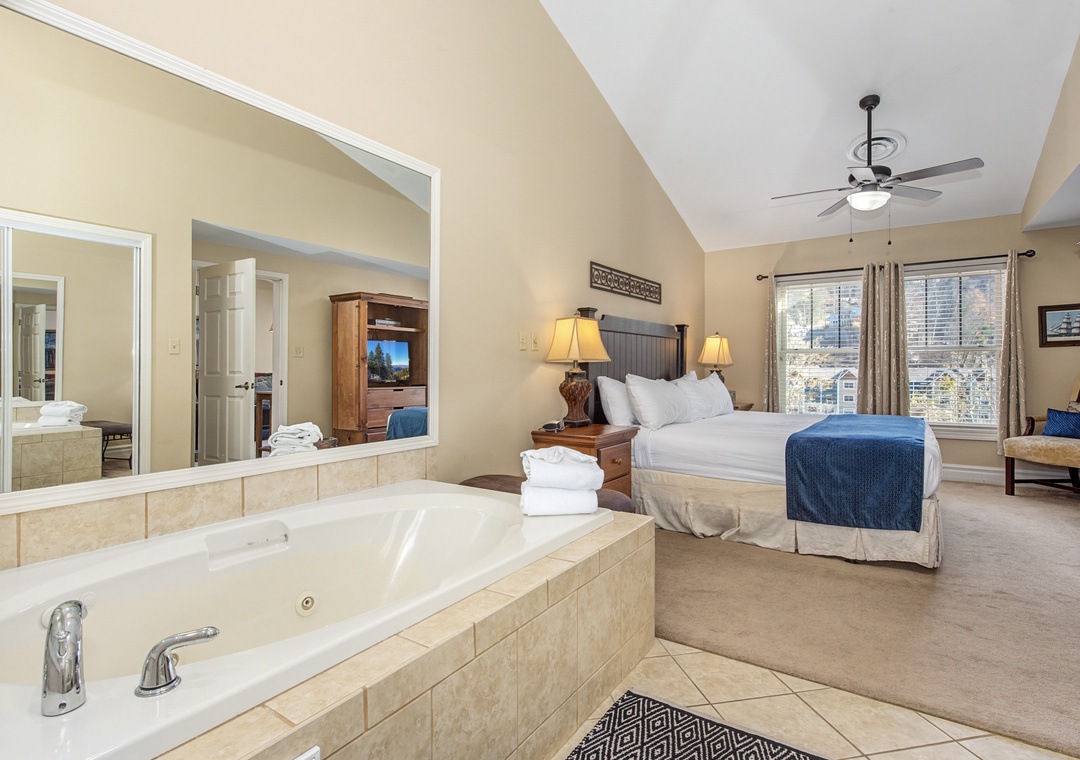 Unwind in your luxurious suite featuring a romantic jetted tub, plush king bed, and charming mountain views from your private windows.