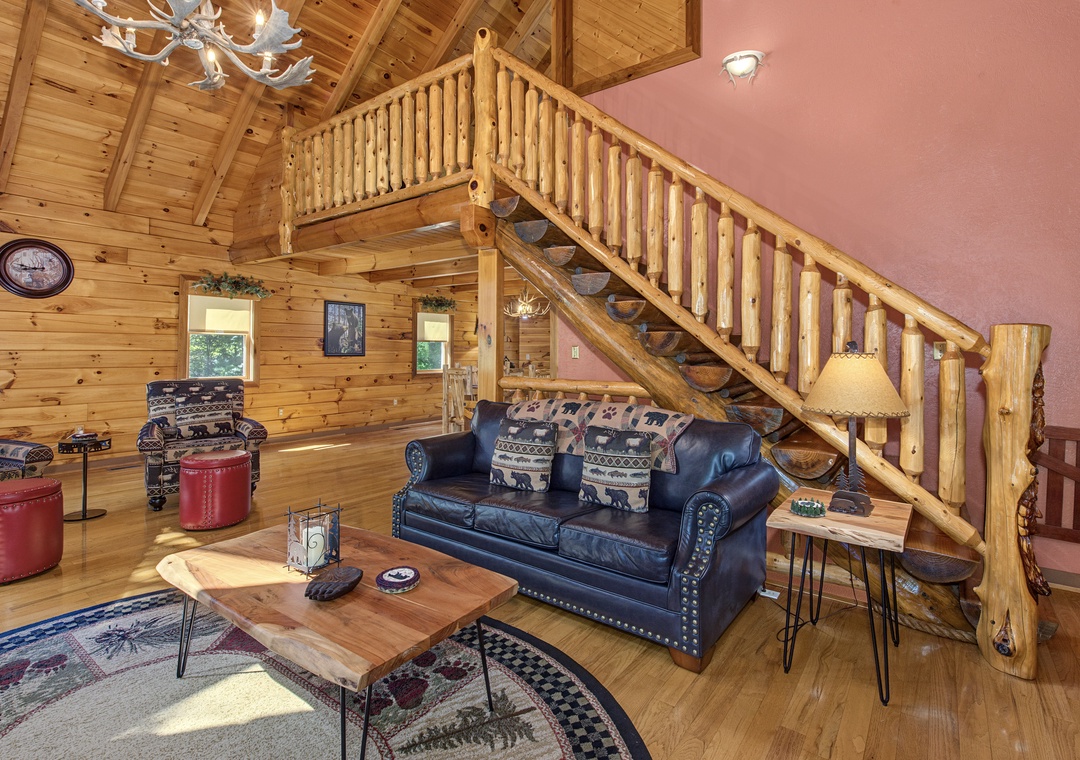 Step into this charming cabin where rustic log beams meet cozy comfort. Relax on the plush leather sofa under soaring vaulted ceilings, with a warm retreat upstairs calling your name.