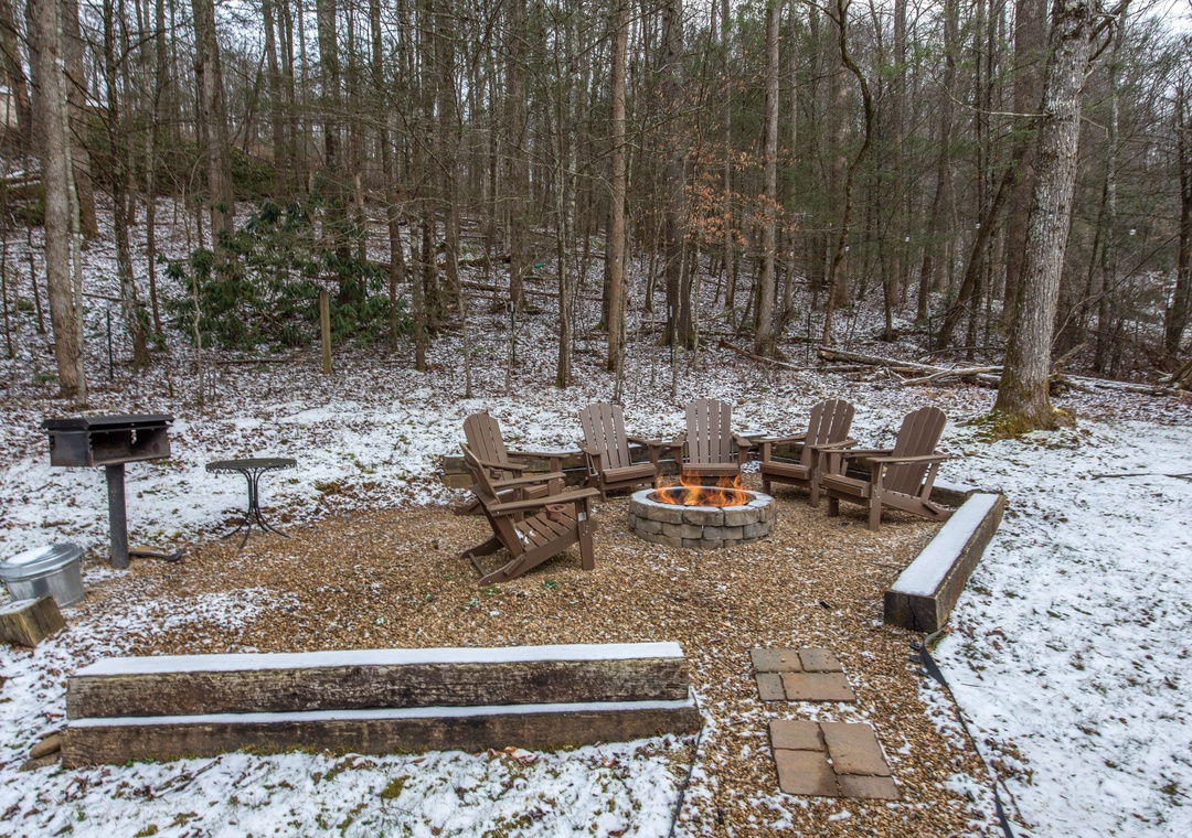 Gather around your private fire pit surrounded by cozy Adirondack chairs, perfect for warming up after winter adventures in the woods.