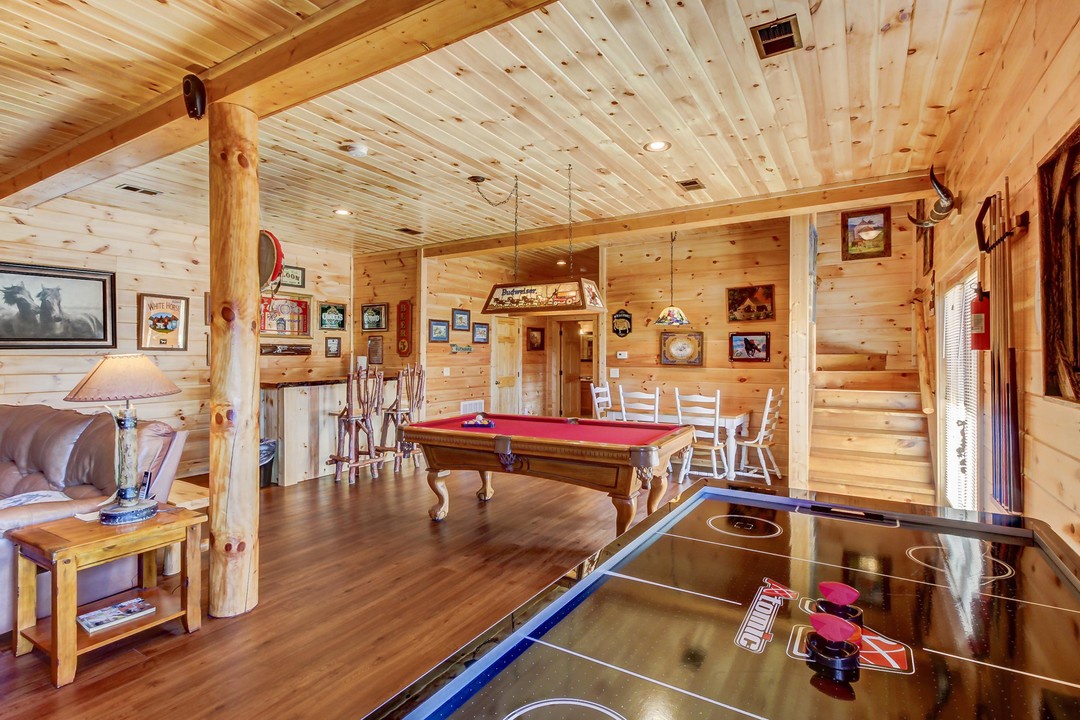 Step into your private game room with a pool table, shuffleboard, and rustic log cabin charm—perfect for friendly competition and making memories with family and friends.