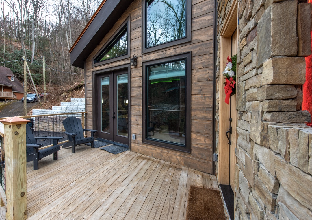 Step onto your private deck with cozy chairs, perfect for morning coffee while surrounded by peaceful wooded views.