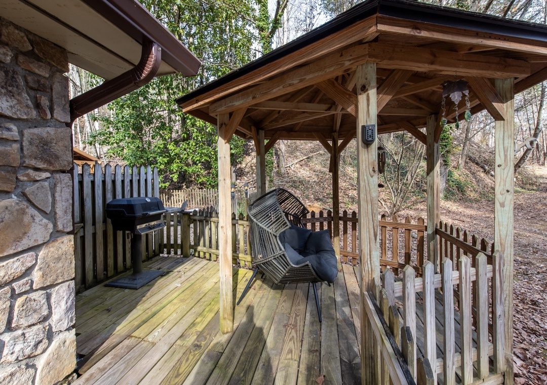 Your covered deck features a cozy swing and BBQ grill, perfect for morning coffee or evening grilling sessions.