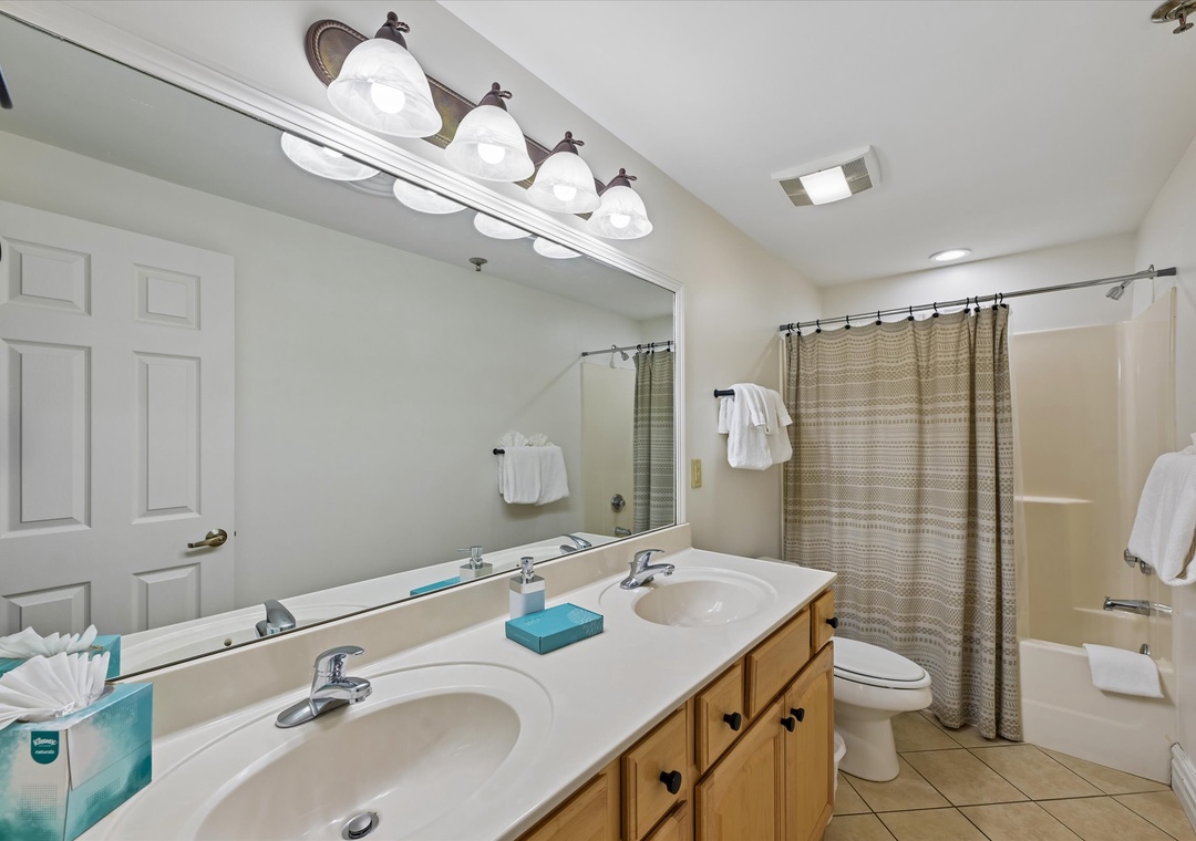 Your spacious bathroom features dual sinks and a relaxing tub-shower combo, perfect for refreshing after your adventures.