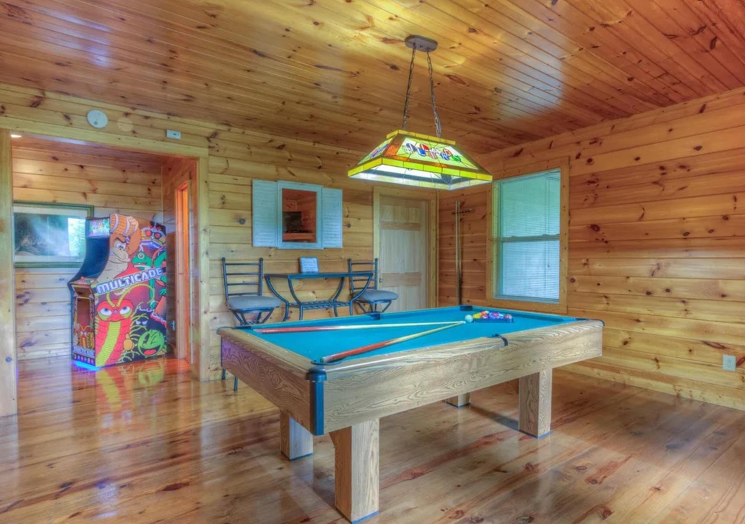 Challenge your travel companions to friendly competition on the full-size billiard table, or unwind with arcade games in this inviting wood-paneled game room designed for your entertainment.