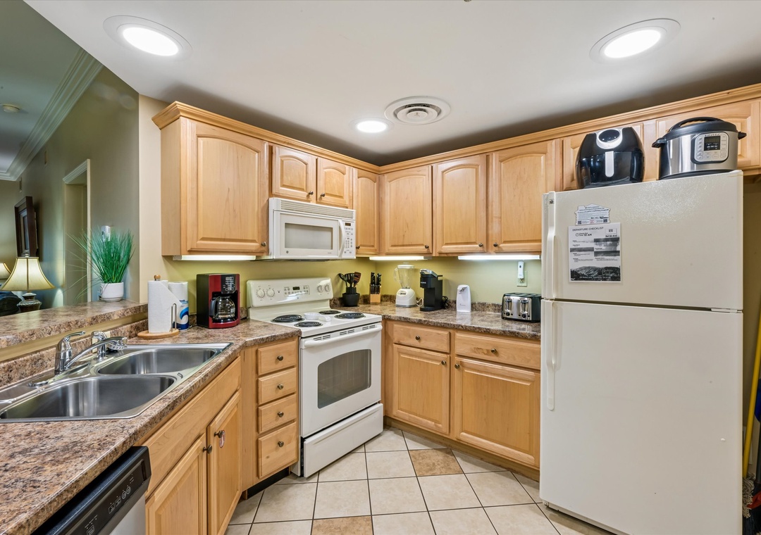 Prepare your favorite meals in this fully equipped kitchen with granite counters, modern appliances, and everything you need for a comfortable stay.