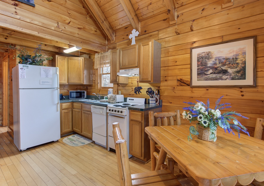 Your rustic log cabin kitchen and dining area await, where wood-beamed ceilings and warm timber walls create the perfect mountain retreat atmosphere.