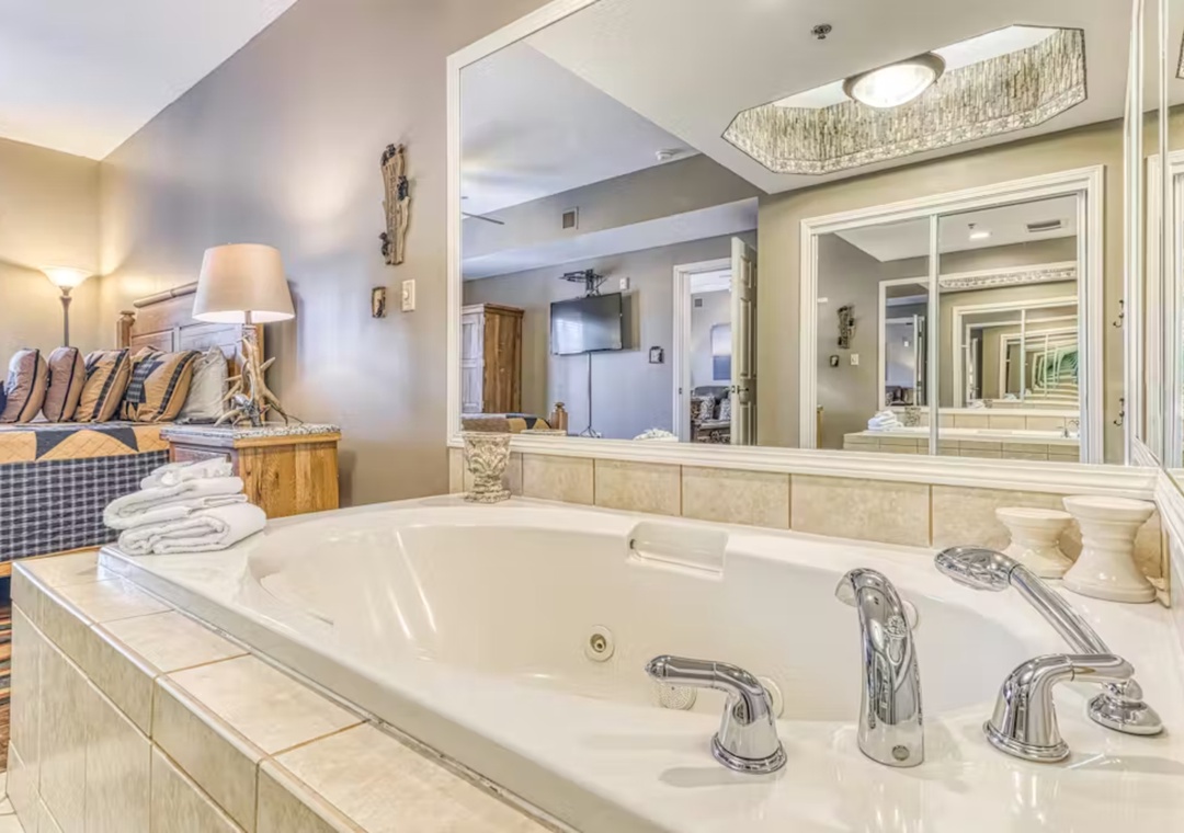 Indulge in your private jacuzzi tub with romantic bedside views, where fluffy towels await your relaxing soak.