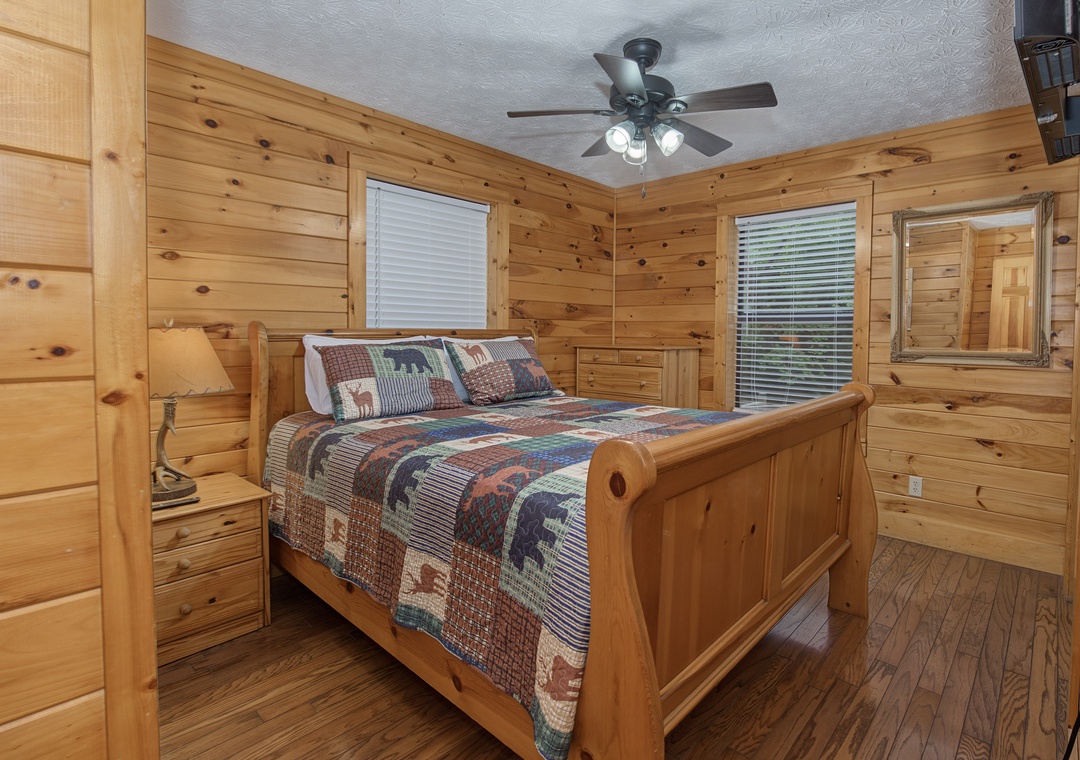 Drift off in your cabin-style bedroom where rustic pine walls create a cozy mountain retreat. The plush quilt and bedside lamps set the tone for restful nights after your adventures.