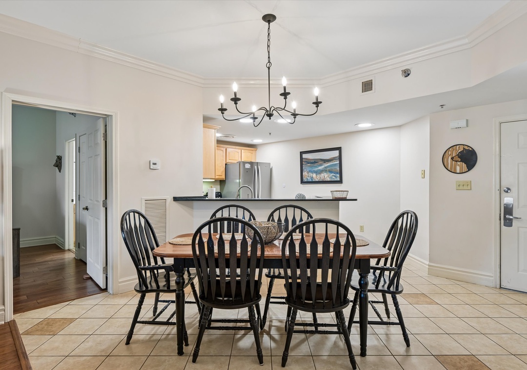 Gather around your welcoming dining table beneath elegant lighting for memorable meals together in your bright, open-concept space.