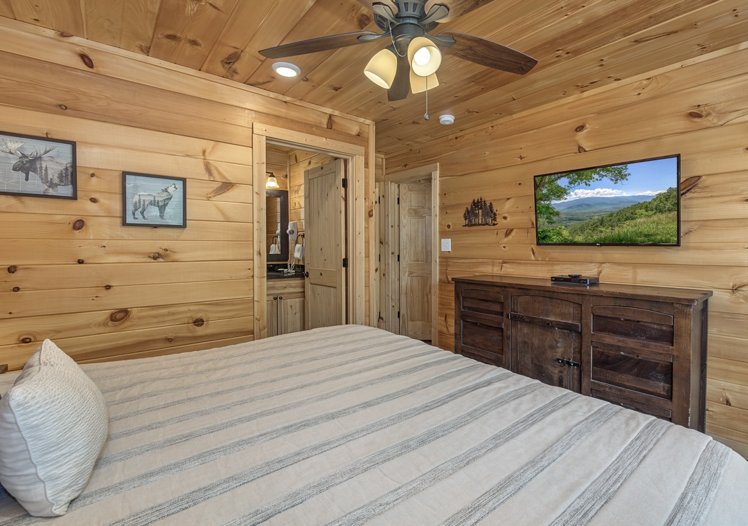 Slip into the cozy warmth of rustic pine walls and a plush bed, where your private retreat awaits. Unwind in charm while gentle ceiling fan breezes help you relax.