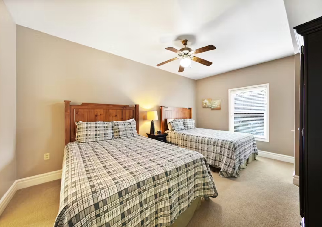Rest peacefully in your comfortable twin bedroom with soft linens, gentle ceiling fan, and warm natural light streaming through the window.