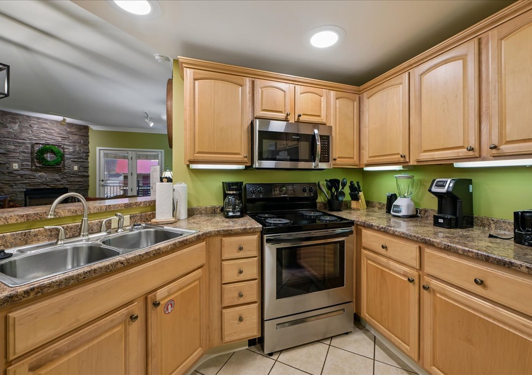 Your fully equipped kitchen features granite counters, stainless appliances, and warm wood cabinets—perfect for preparing memorable meals during your stay.