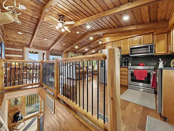 Step into this stunning open-concept loft where rustic charm meets modern comfort. Your fully-equipped kitchen features stainless appliances under soaring wood-beamed ceilings.