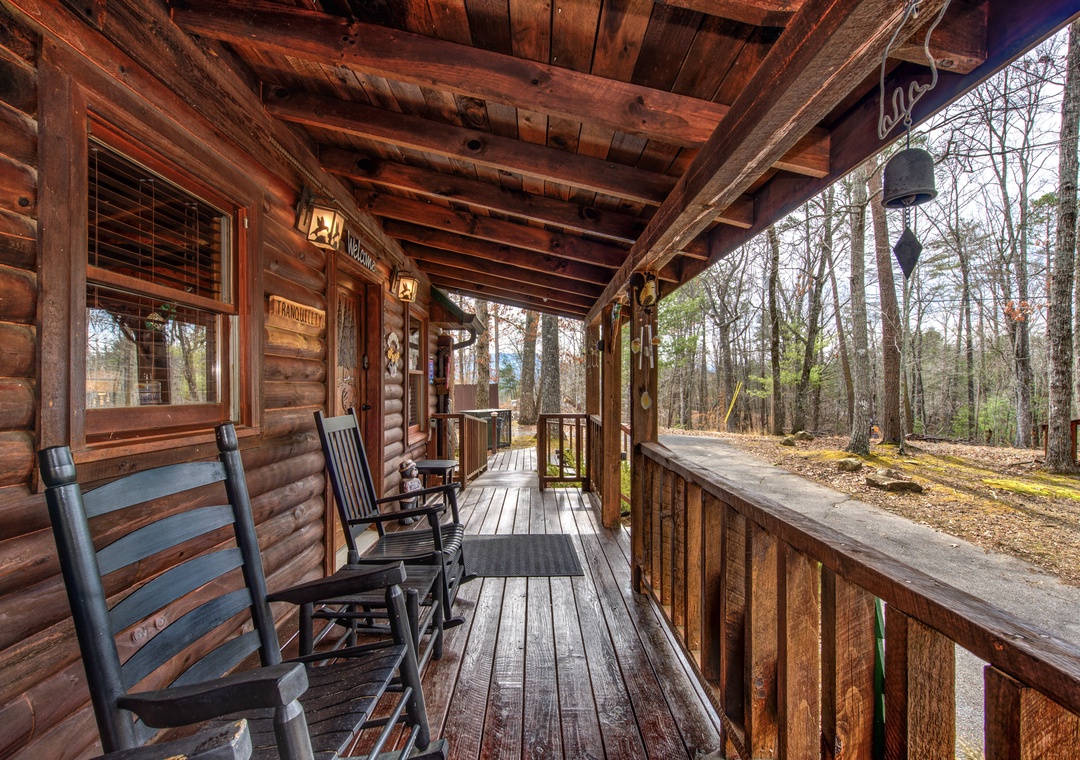 Step onto your private covered porch and settle into rustic rocking chairs, where forest views and gentle breezes create the perfect retreat.