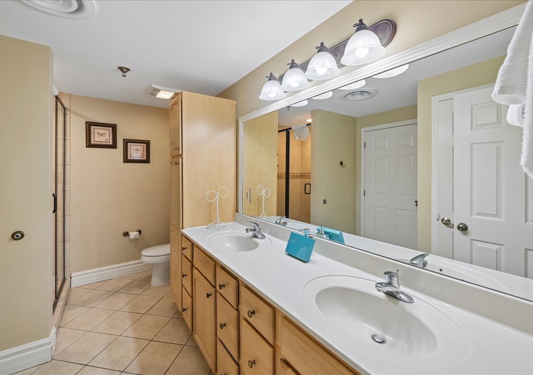 Your spacious bathroom features dual vanities and ample storage, making your morning routine effortless and comfortable.