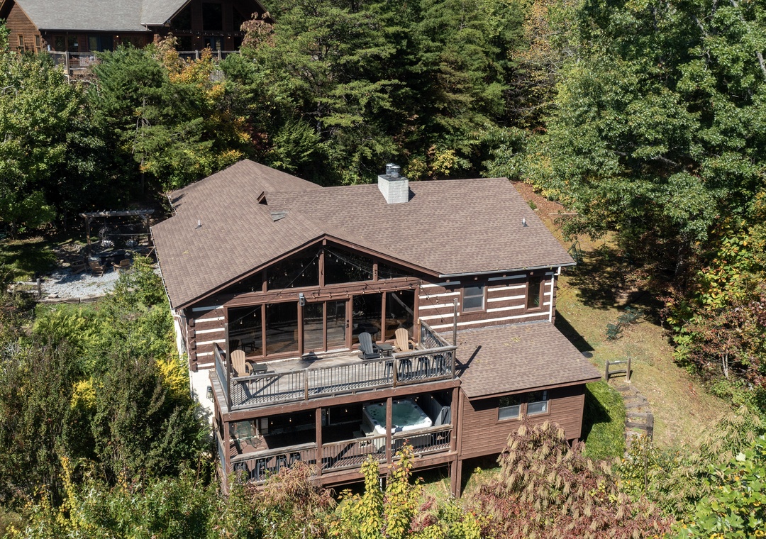 A rustic mountain retreat nestled in lush forest, surrounded by towering trees and peaceful natural beauty.