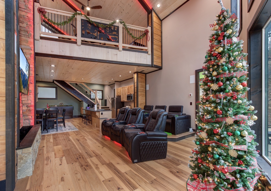 Gather around the festive Christmas tree in your spacious living room, where plush theater seating awaits cozy movie nights.