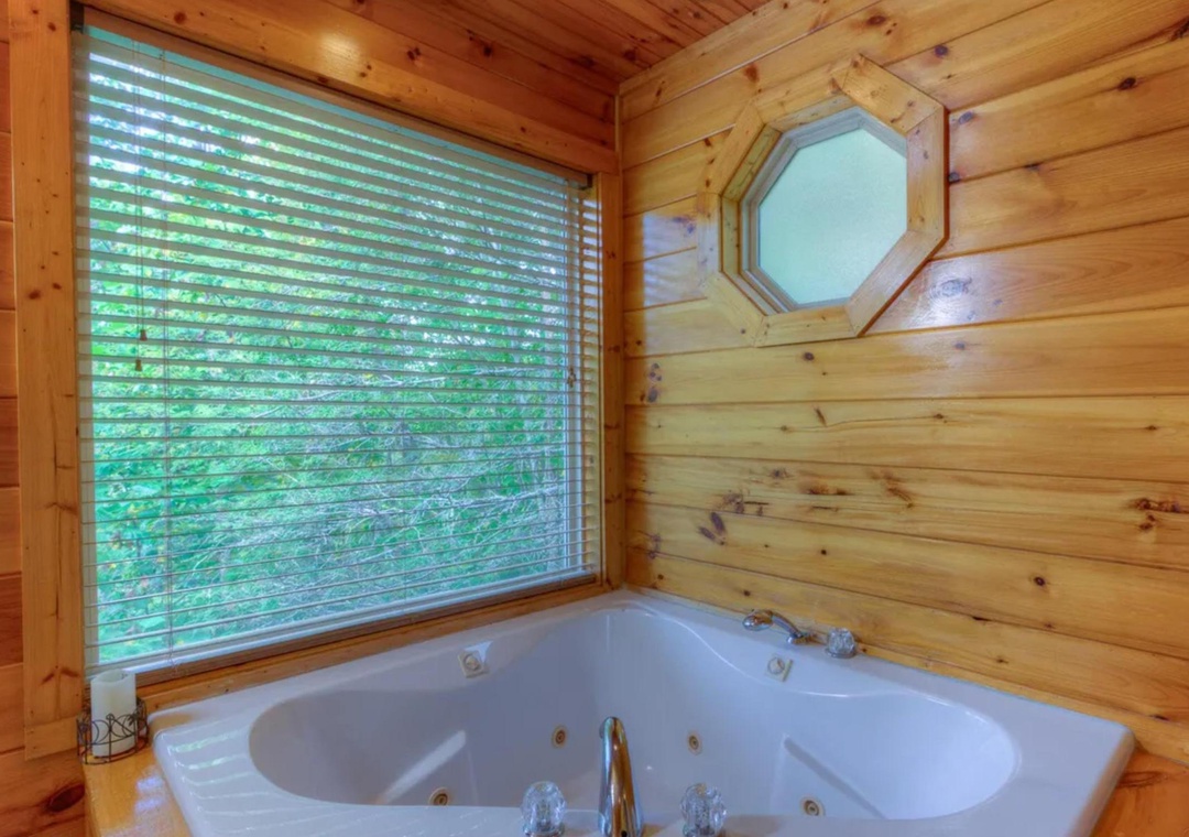 Sink into your own private jetted tub surrounded by warm, natural wood. The lush garden view creates a serene escape where you can unwind completely.