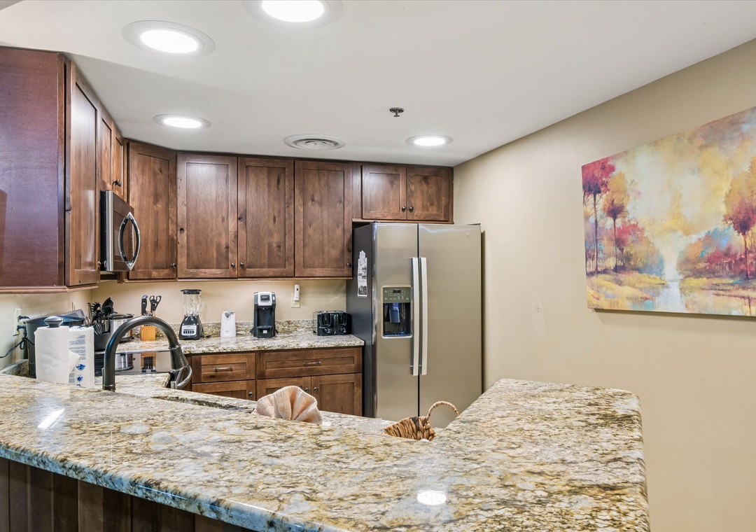 Your fully equipped kitchen features granite counters, stainless appliances, and rich wood cabinets for home-cooked meals.