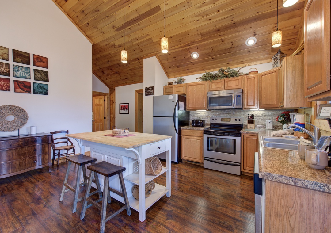 Your spacious kitchen invites culinary adventures with granite counters, stainless appliances, and a cozy breakfast island where morning coffee tastes even better.