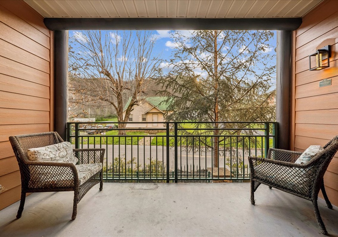 Unwind on your private covered balcony with cozy wicker seating, where you can sip your morning coffee while enjoying peaceful neighborhood views.
