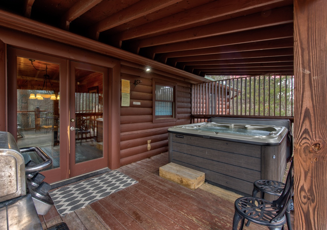 Unwind on your private covered deck with bubbling hot tub and forest views—perfect for starlit soaks after mountain adventures.