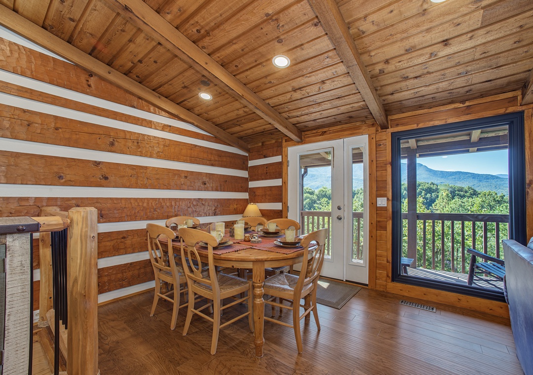Gather around the handcrafted wood table under soaring timber beams and take in stunning mountain views through your private balcony doors—breakfast here feels like a retreat into nature.