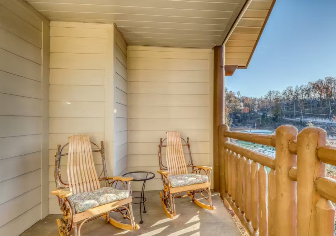 Unwind in your private balcony retreat with comfortable rocking chairs and peaceful forest views.