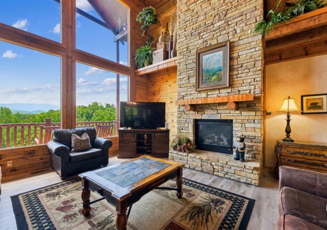 Sink into plush leather seating by your floor-to-ceiling stone fireplace, while sunlight streams through towering windows framing lush mountain vistas. The perfect spot to unwind after your adventures.