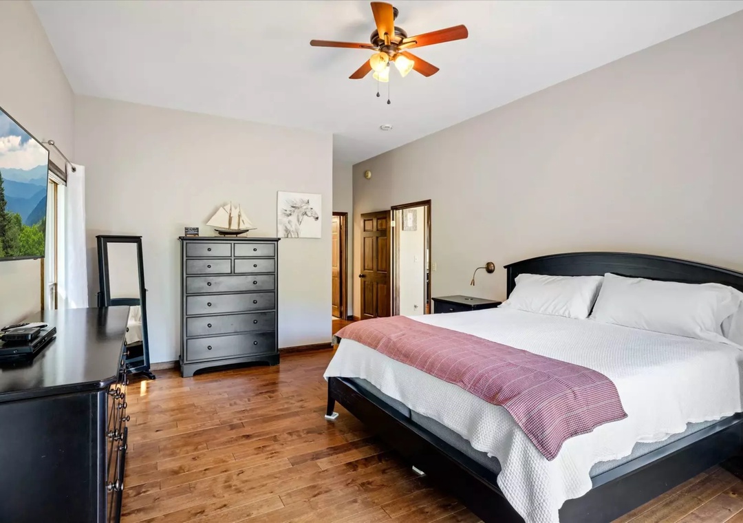 Your peaceful bedroom retreat features a comfortable bed with fresh linens and mountain views to start your mornings right.