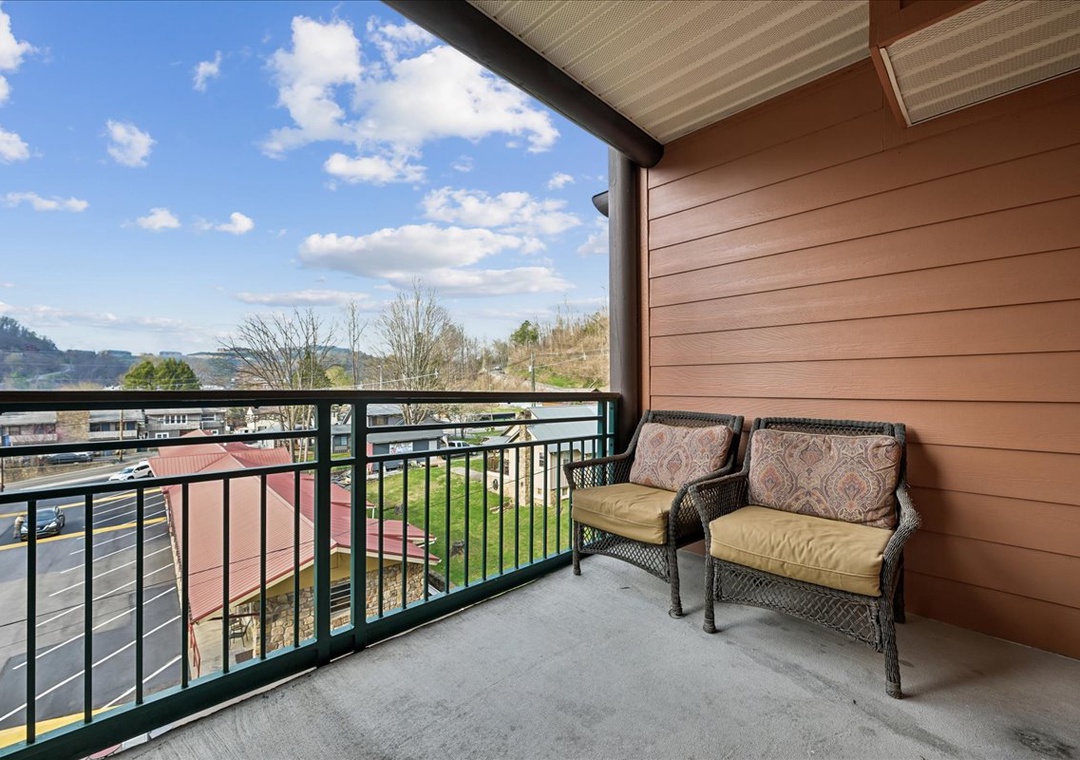 Relax in comfortable wicker chairs while enjoying sweeping mountain and valley views from your private balcony.