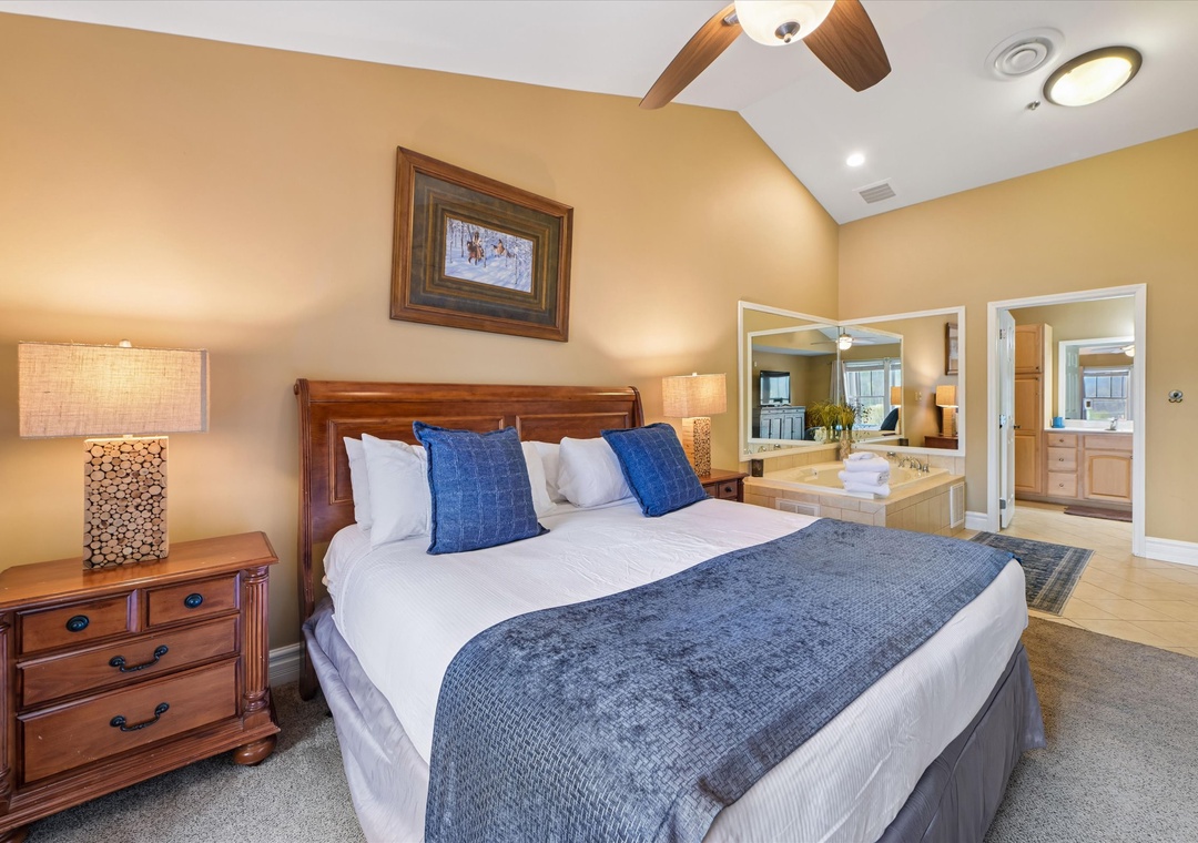 Drift off to sleep in your elegant bedroom featuring a plush king bed with crisp linens and beautiful wood furnishings that create the perfect retreat.