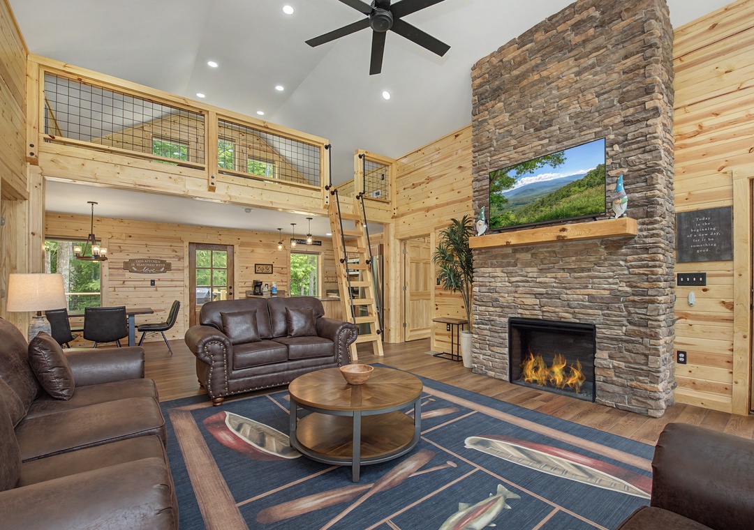 Relax in your spacious great room with soaring ceilings, a cozy stone fireplace, and leather seating that invites you to unwind after mountain adventures.