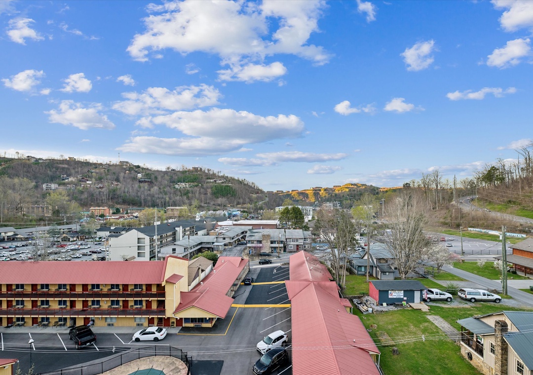 Aerial view of the property nestled in the scenic Tennessee hills with rolling mountains and charming downtown area nearby.