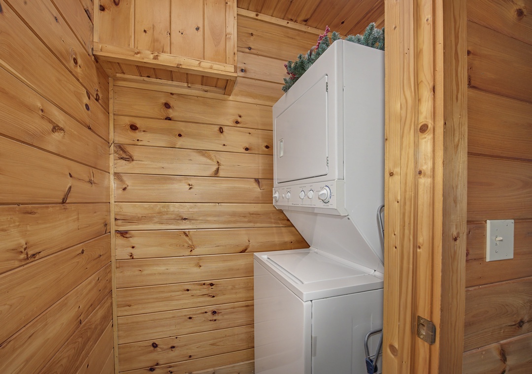 Your own washer and dryer in a cozy wood-paneled nook makes packing light a breeze—enjoy the cabin vibes while keeping your laundry fresh.